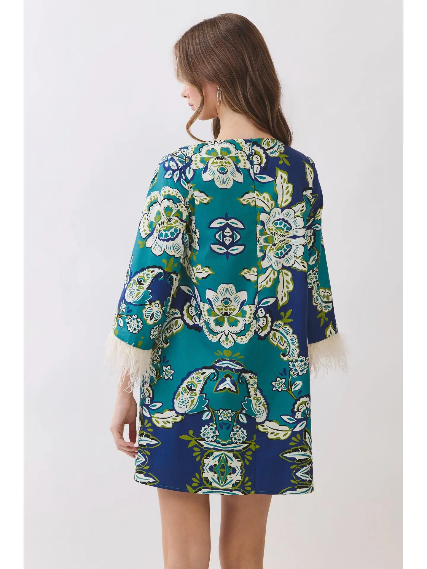 A sleeveless mini dress featuring an abstract football inspired print throughout. Designed with a round neckline, fitted silhouette, and an open back keyhole detail with self-tie closure.